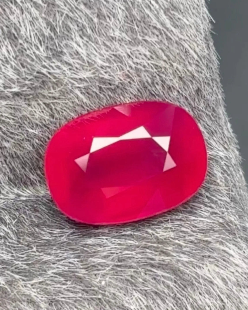 1.55 CTS Natural red Ruby oval main view showing saturated colour, faceted crown and natural crystal detail | SARATTI