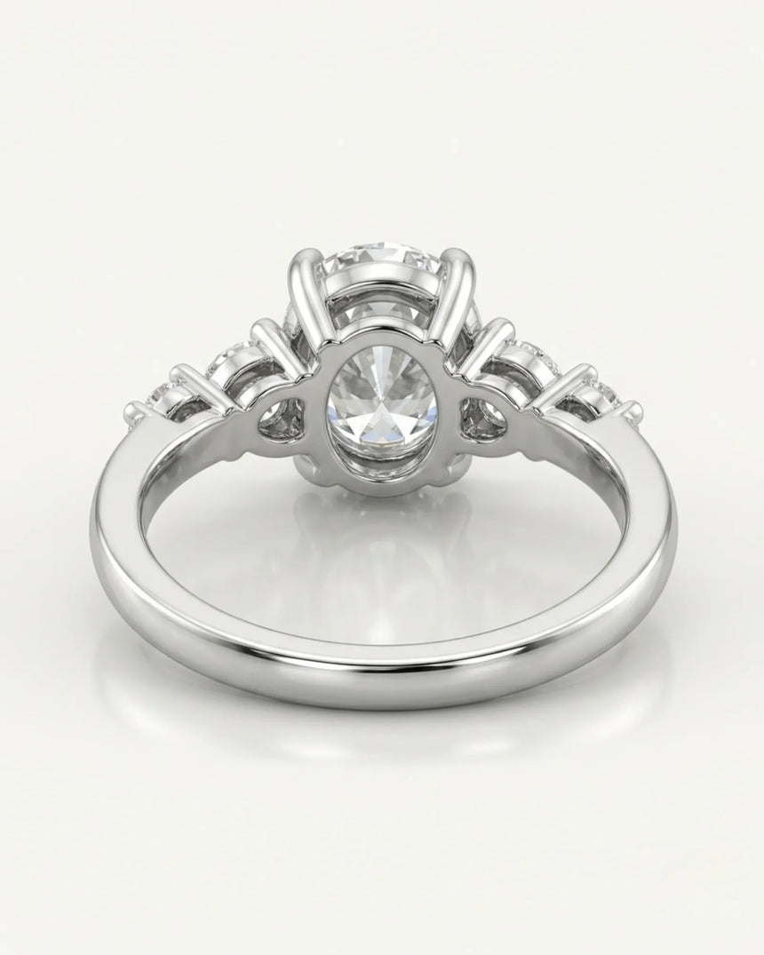 Classic five stone moissanite ring with oval center and sculptural prongs in platinum | SARATTI