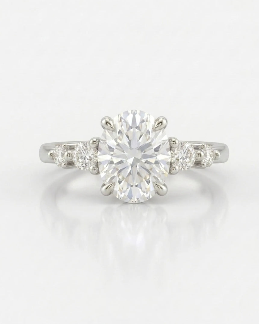 Classic five stone moissanite ring with oval center and sculptural prongs in white gold | SARATTI