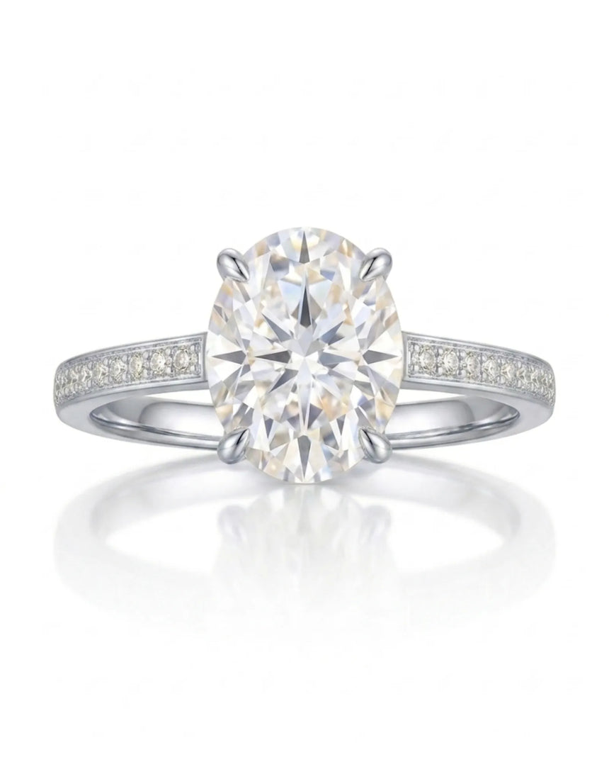 Classic oval moissanite ring with four prong setting and pavé band in platinum | SARATTI