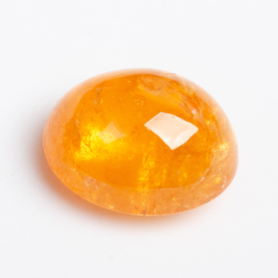 Close-up of 2.47ct oval orange Spessartine Garnet loose stone | SARATTI