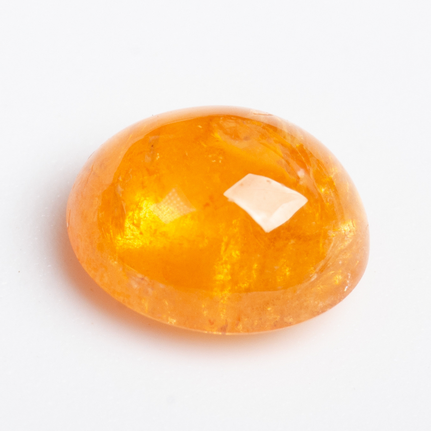Close-up of 2.47ct oval orange Spessartine Garnet loose stone | SARATTI