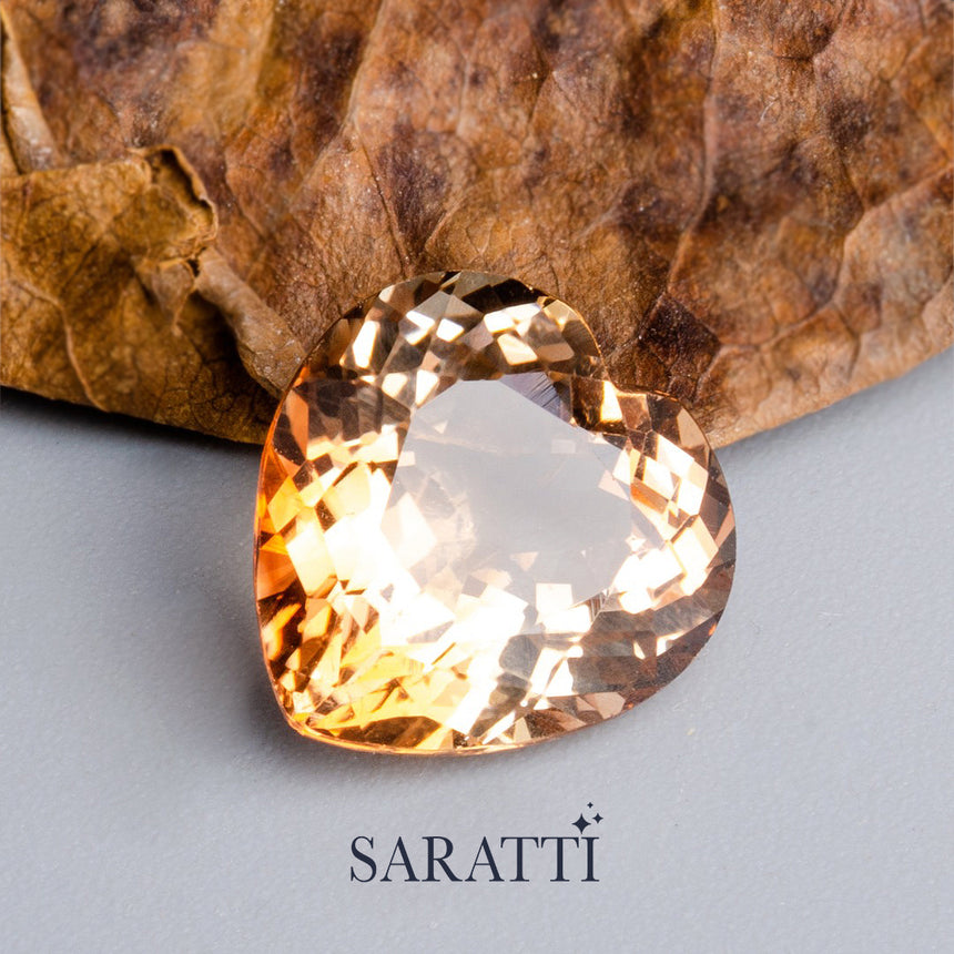 Close-up of 7.48 carat Natural Imperial Topaz heart cut gemstone | SARATTI
