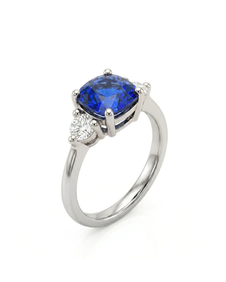 Cushion blue sapphire ring with two round diamonds in platinum | SARATTI