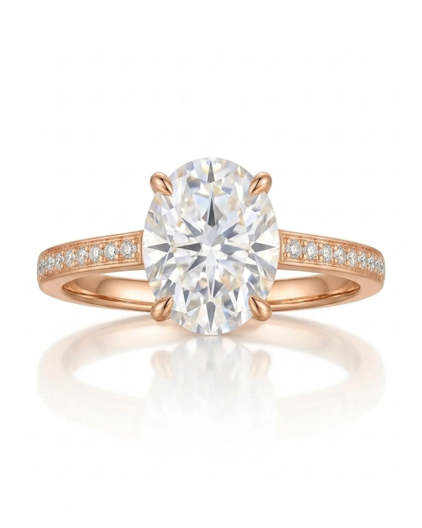 D color oval moissanite center framed by round accents in polished 18K rose gold | SARATTI