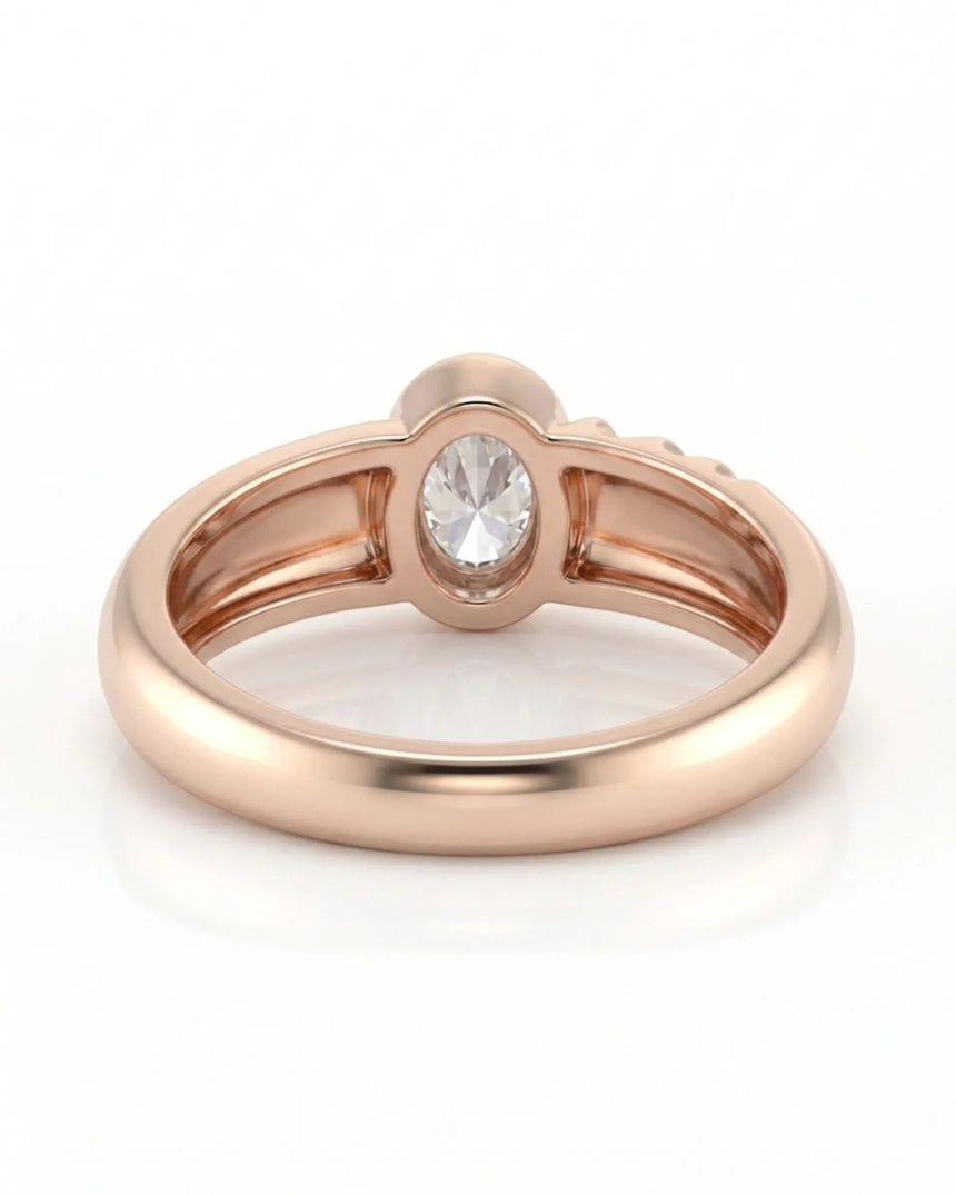 D color oval moissanite framed by a smooth bezel in softly polished 18K rose gold | SARATTI