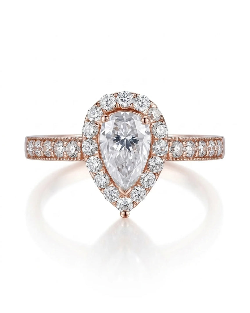 D color pear moissanite center framed by round accents in polished 18K rose gold | SARATTI