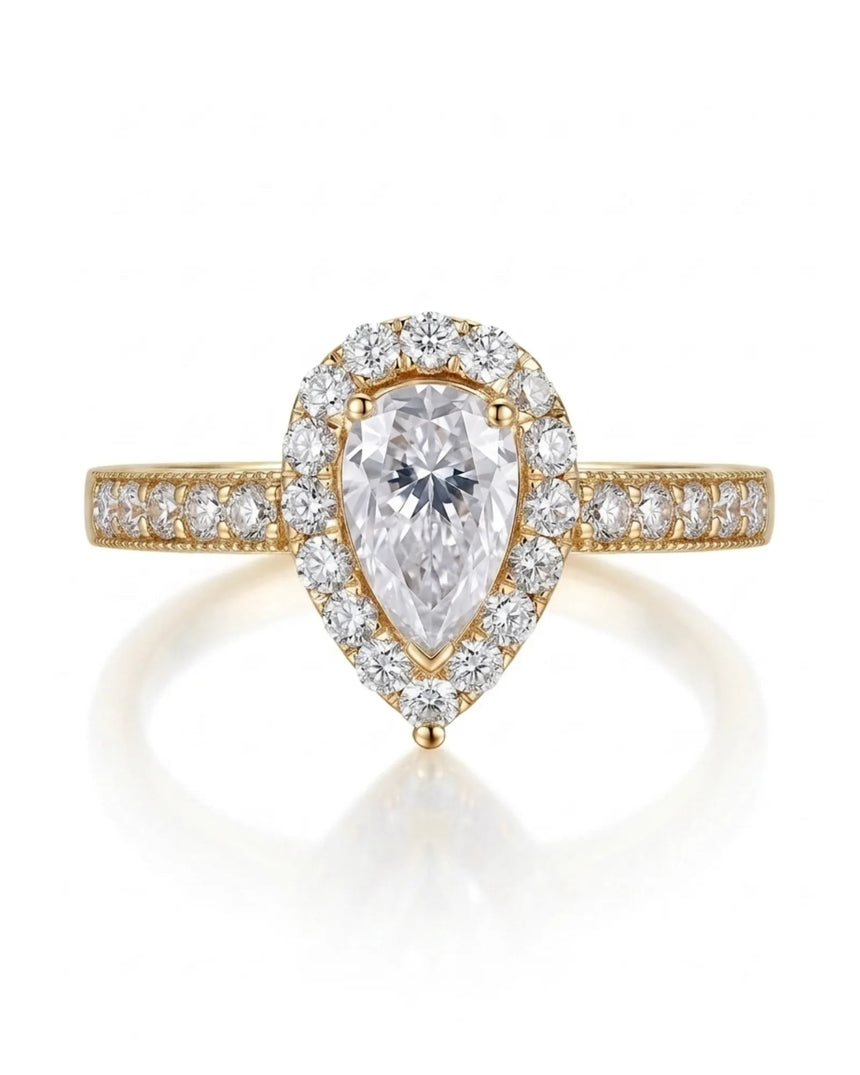 D color pear moissanite center framed by round accents in polished 18K yellow gold | SARATTI