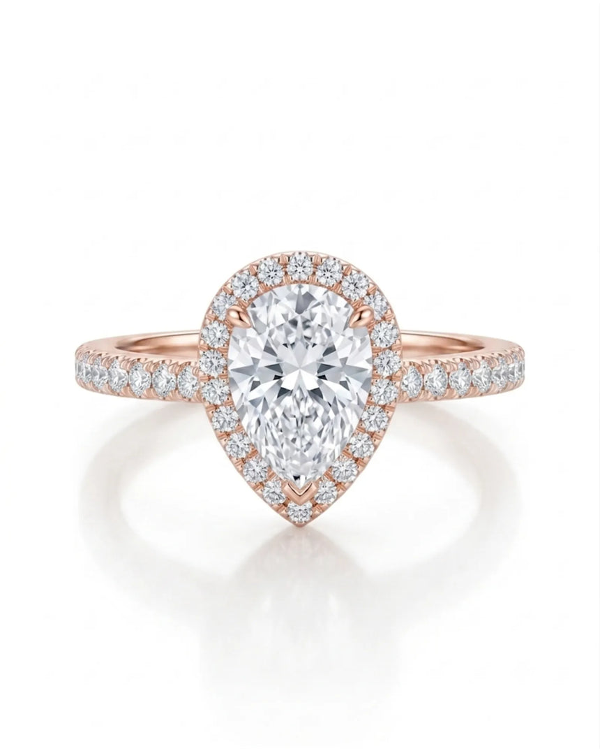 D color pear moissanite center framed by round accents in softly polished 18K rose gold | SARATTI
