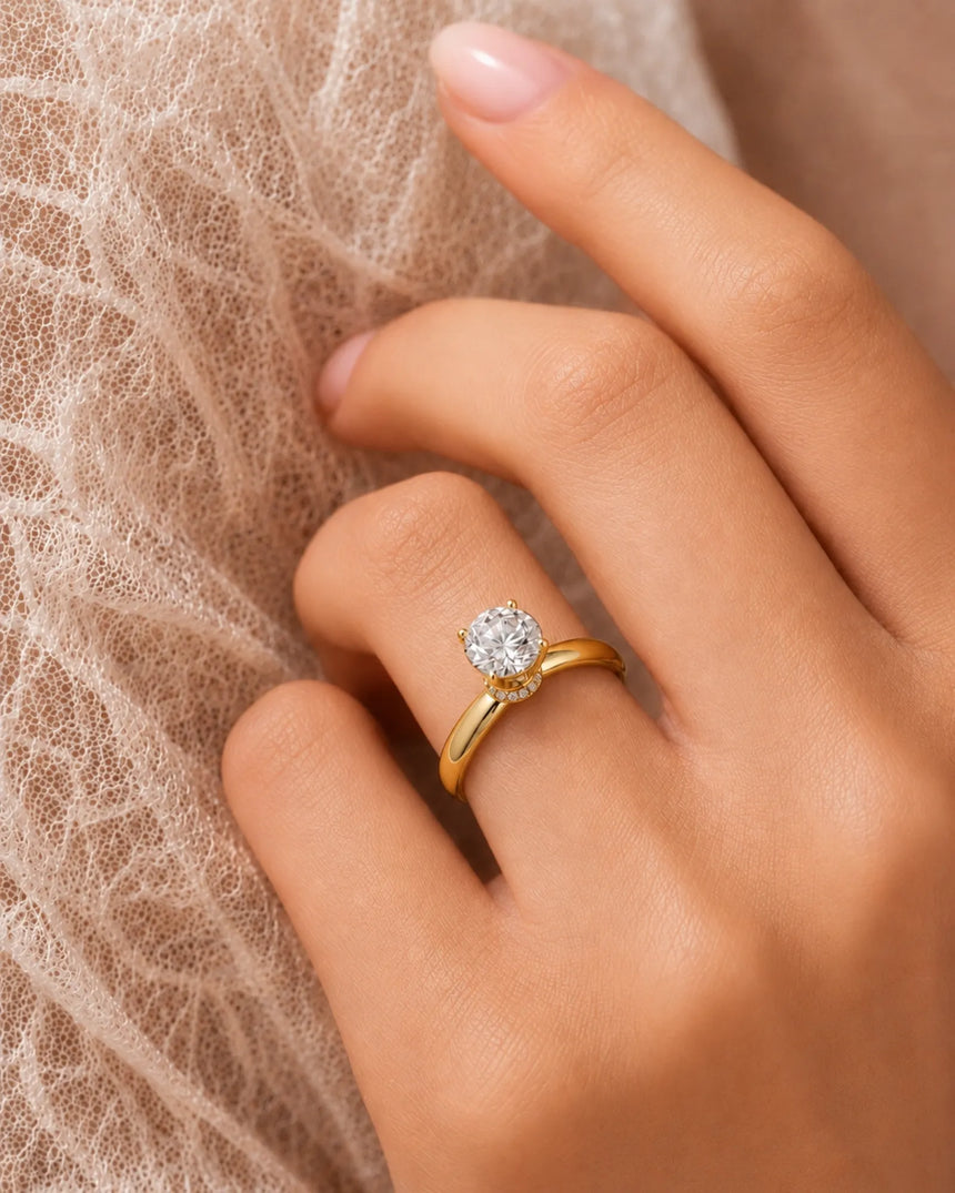 D color round moissanite center with discreet pavé accents in warm 18K yellow gold | SARATTI