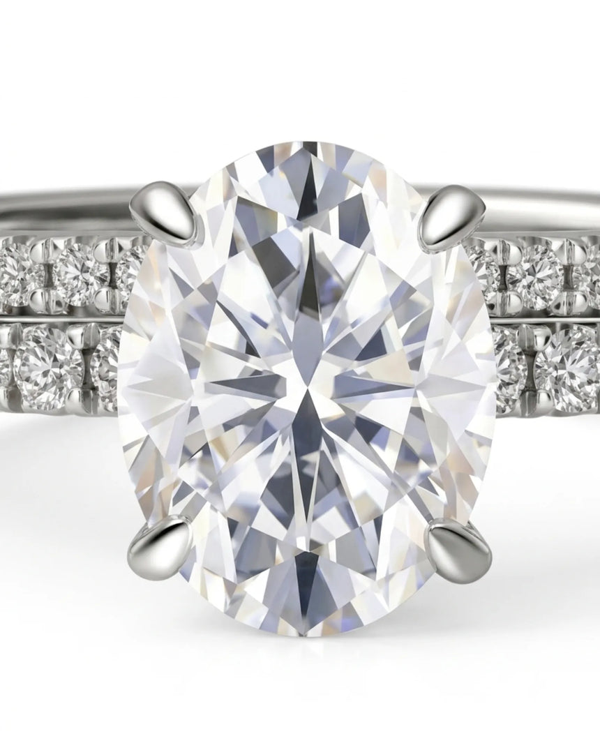 D colorless oval moissanite engagement ring with round accent stones and matching platinum wedding band | SARATTI