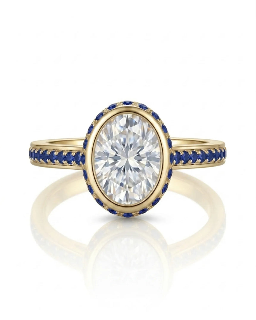 D colorless oval moissanite framed by vivid blue sapphires in polished 18K yellow gold | SARATTI