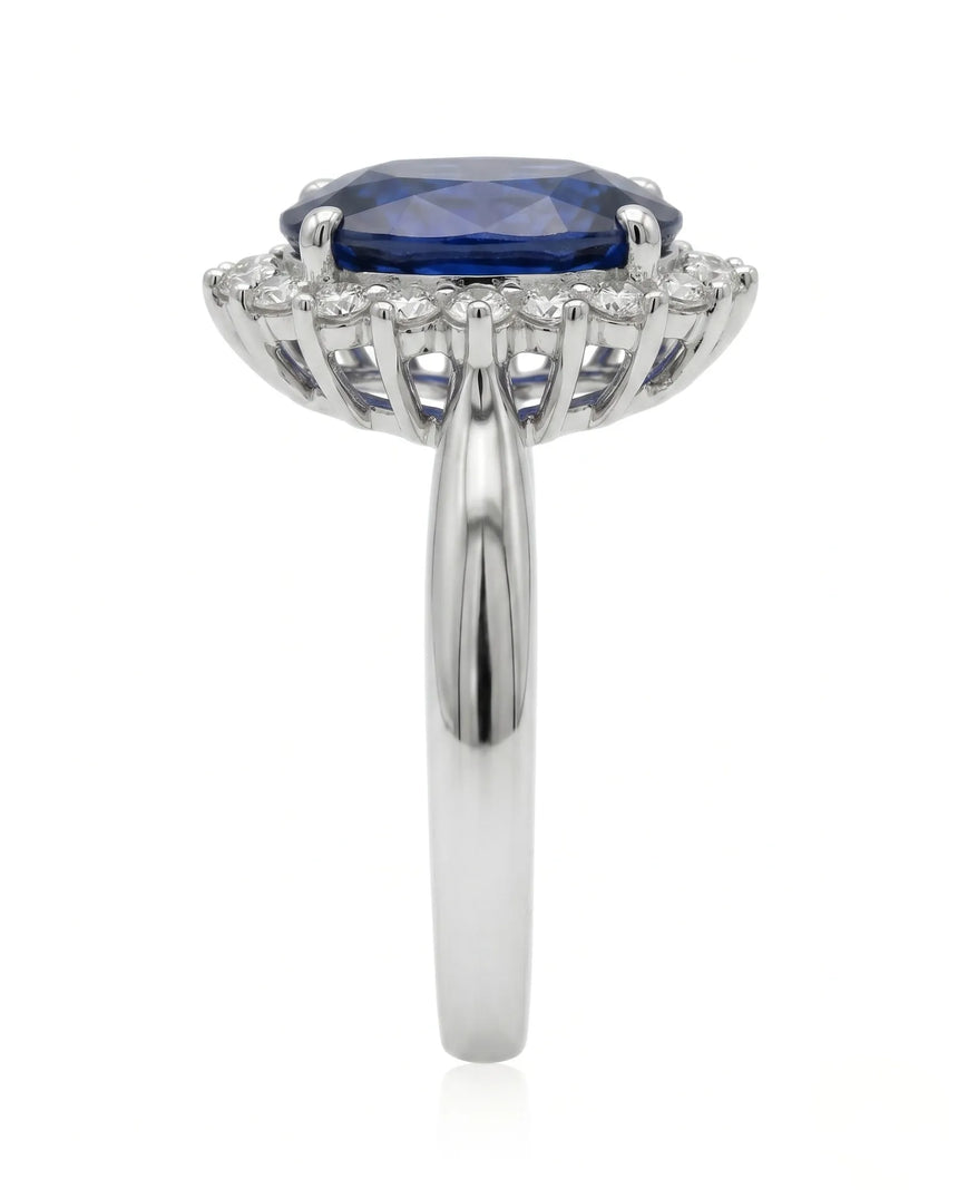 Deep blue oval sapphire ring with brilliant diamond frame in enduring platinum | SARATTI