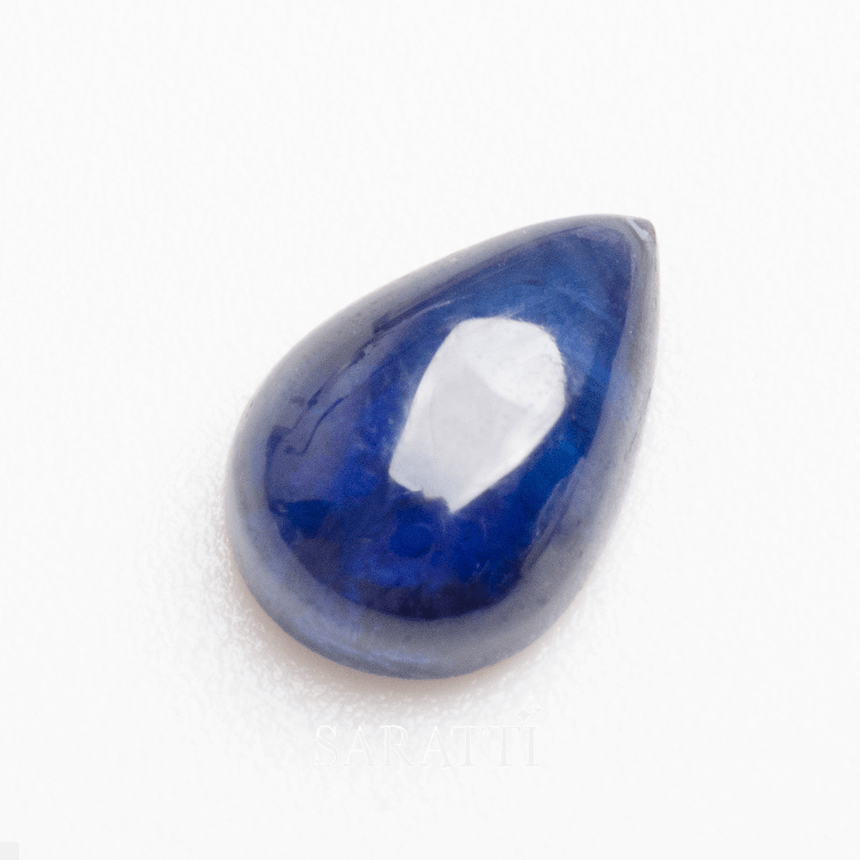 Deep blue pear sapphire gemstone close-up showcasing luster | SARATTI