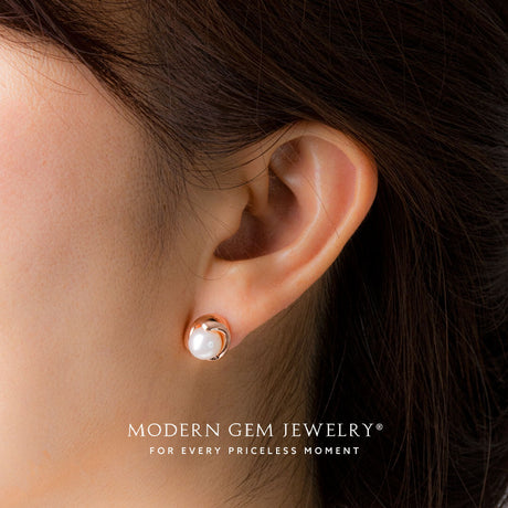 Model wears bezel set natural akoya pearl earrings