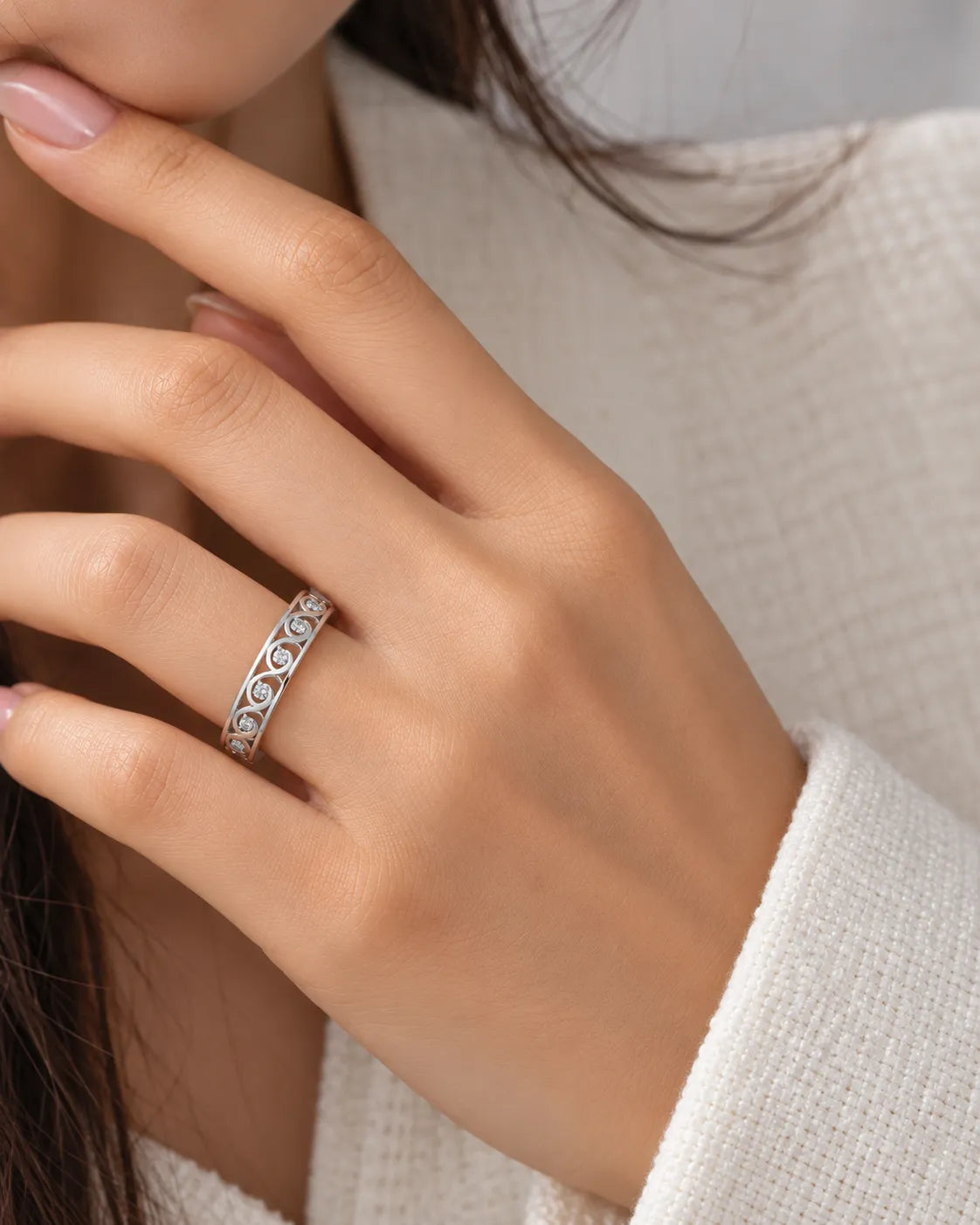Art Nouveau diamond wedding band styled on a hand, highlighting the flowing ornamental design | SARATTI