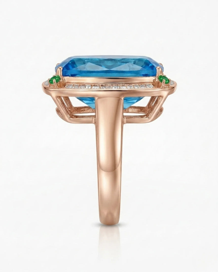 Elongated cushion Swiss Blue topaz ring bordered by baguette diamonds in polished 18K rose gold | SARATTI