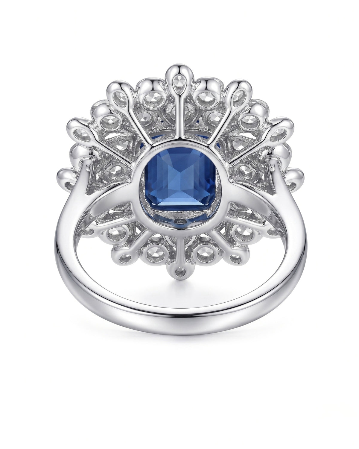 Emerald-cut royal blue sapphire ring framed by white diamonds in platinum | SARATTI