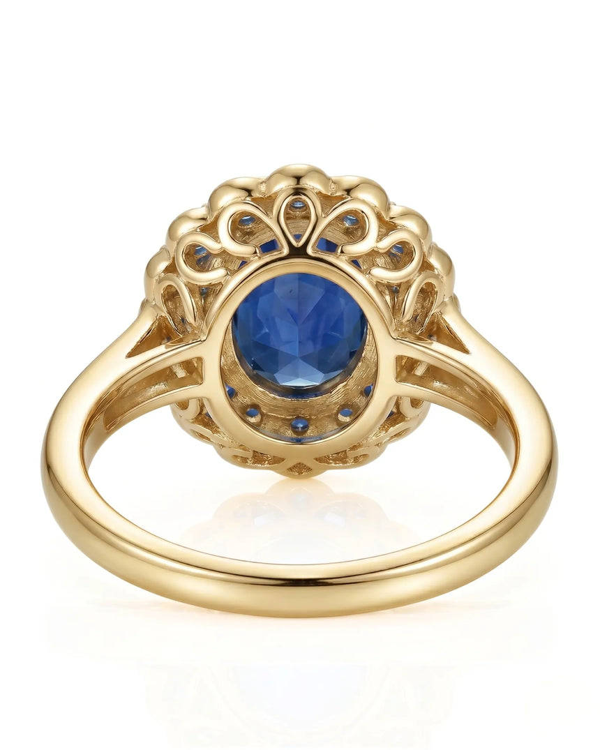 Floral sapphire ring with round diamond halo and blue sapphire border in 18K yellow gold | SARATTI