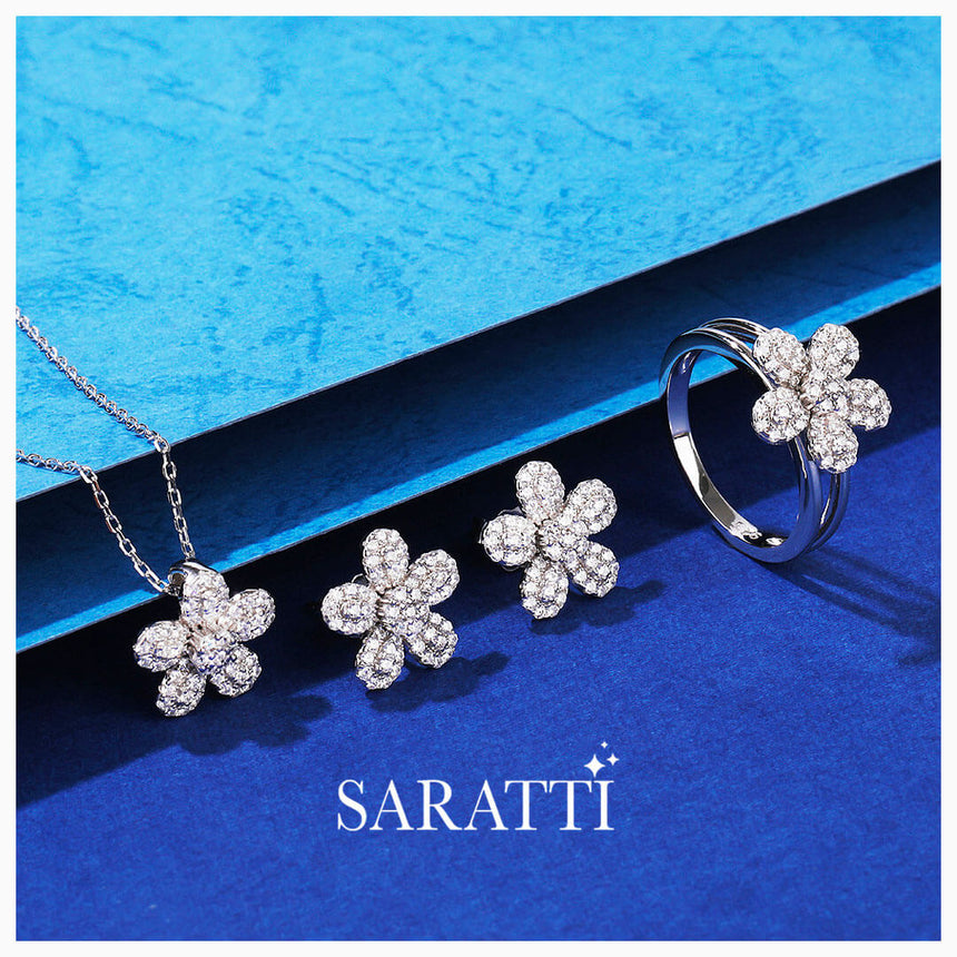 Spotlight shot of the Silver Starry Dream Pendant Necklace with accompanying earrings and a ring | Saratti