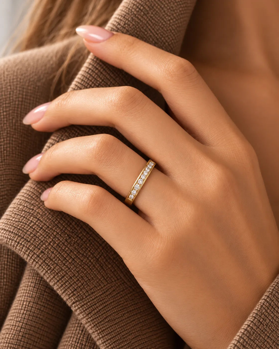 18K yellow gold channel-set diamond wedding band shown on textured fabric | SARATTI