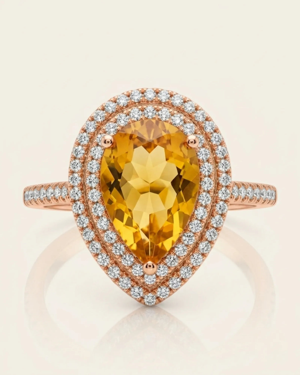 Golden pear-cut citrine surrounded by brilliant diamonds in a warm 18K rose gold ring | SARATTI