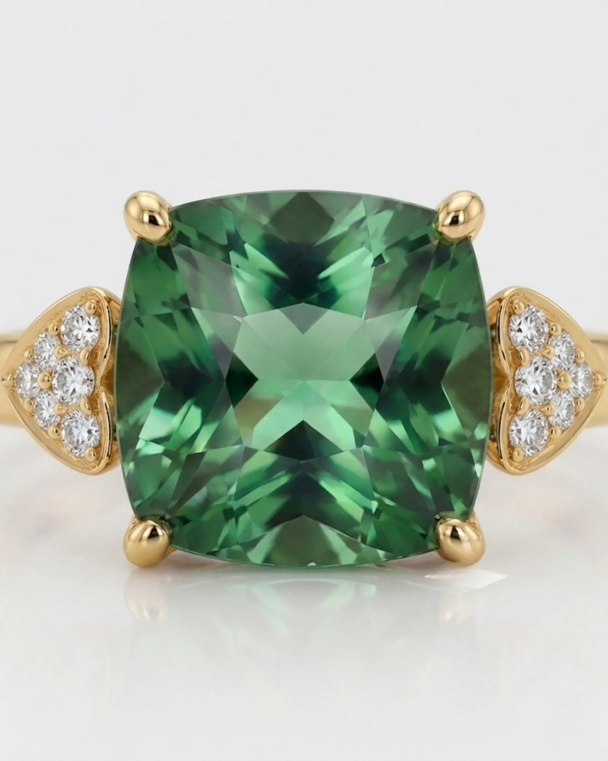 Green tourmaline engagement ring with heart-shaped diamond shoulders in 18K yellow gold | SARATTI