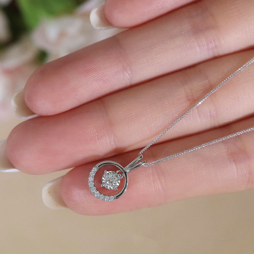 Model cradles the diamond pendant of the Aura di Diamante Diamond Necklace | Saratti