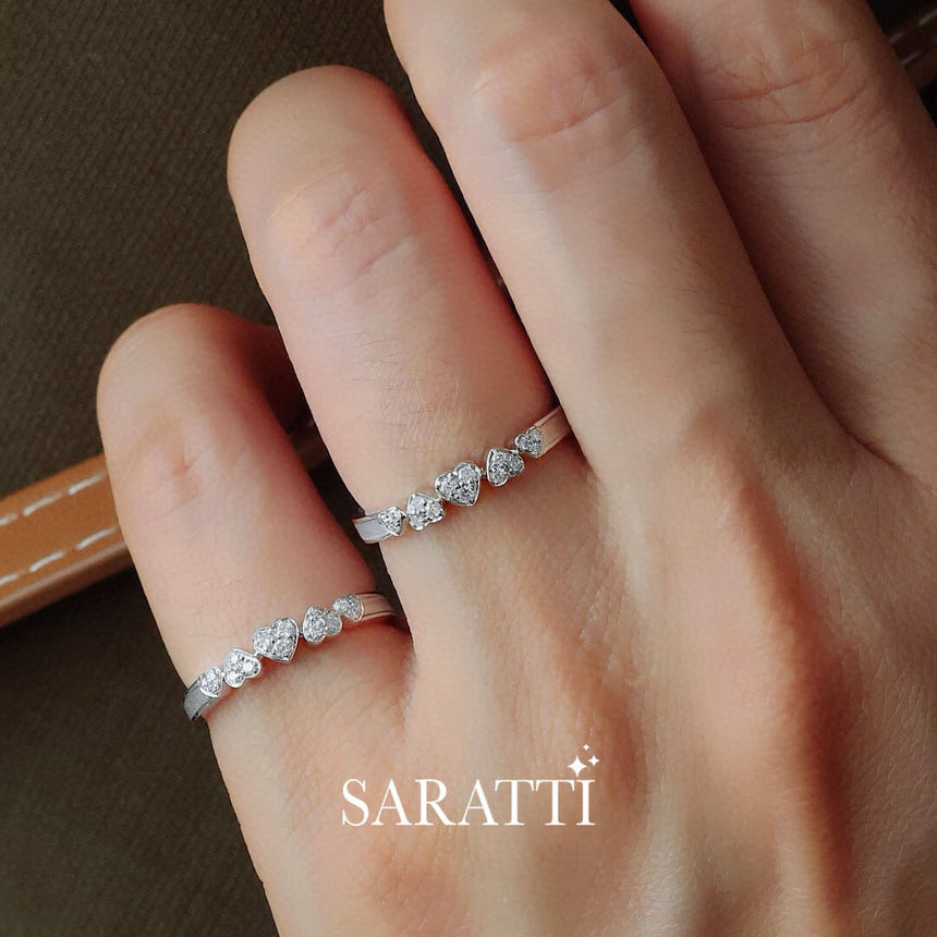 Top Side View of the 18K White Gold Five Heart Diamond Eternity Wedding Bands worn by a model | Saratti