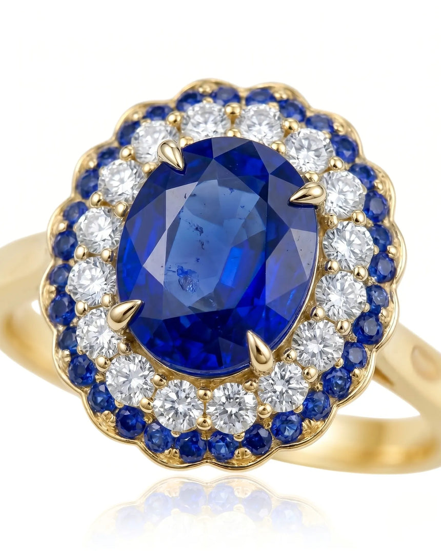 Luxury blue sapphire ring with layered diamond and sapphire halo in 18K yellow gold | SARATTI