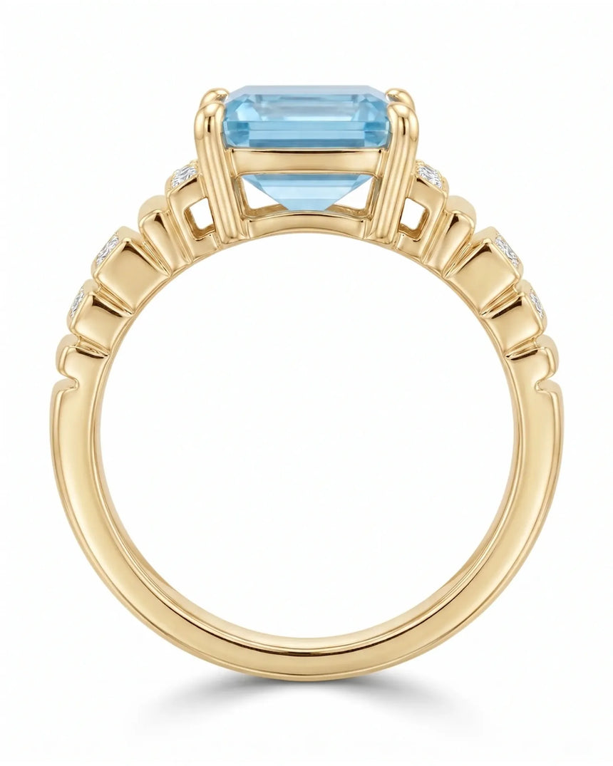 Luxury emerald cut aquamarine ring with round diamonds and warm yellow gold structure | SARATTI