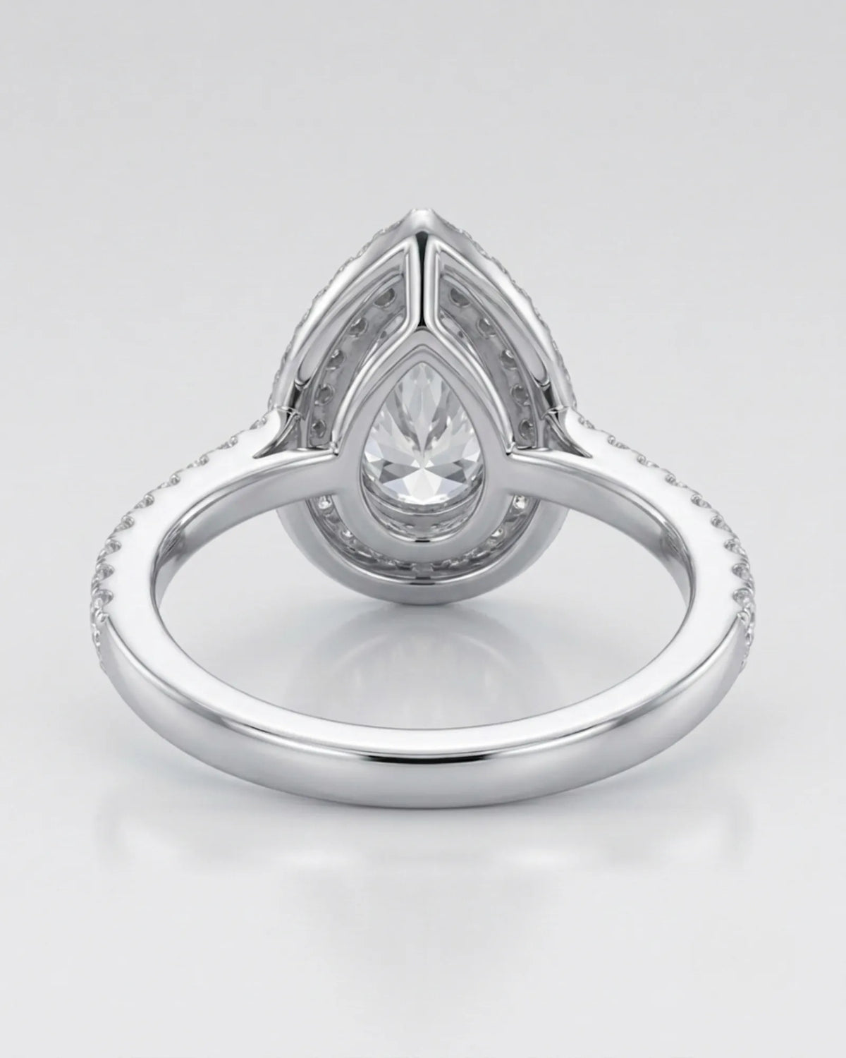Luxury moissanite ring with pear center, scalloped halo, and pavé platinum shoulders | SARATTI