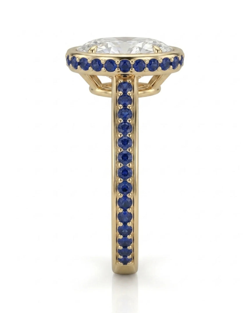 Luxury oval moissanite and natural sapphire ring with protective bezel in 18K yellow gold | SARATTI