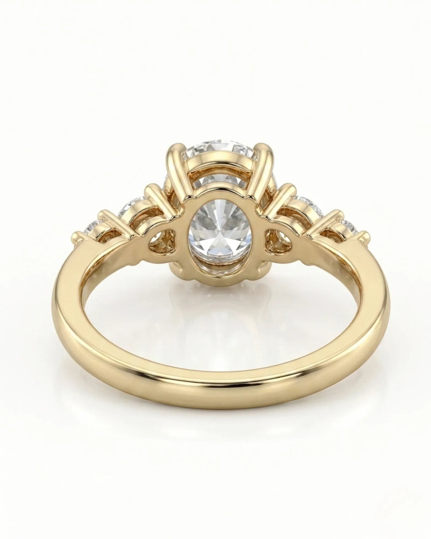 Luxury oval moissanite ring with graduated side stones and rich yellow gold setting - SARATTI