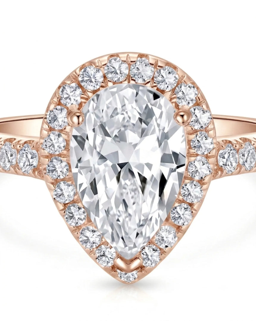 Luxury pear halo moissanite ring combining brilliant accents with warm rose gold elegance | SARATTI
