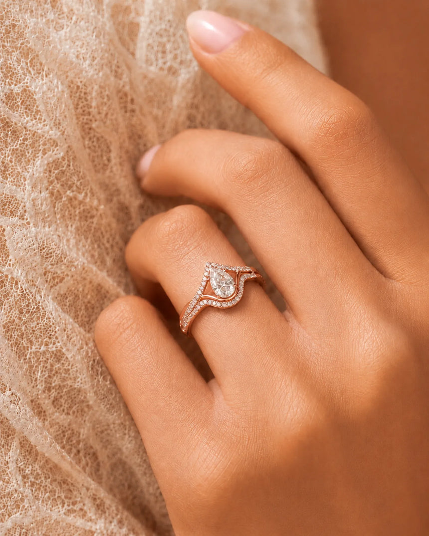 Luxury pear moissanite bridal ring set with sculptural lines in refined 18K rose gold | SARATTI