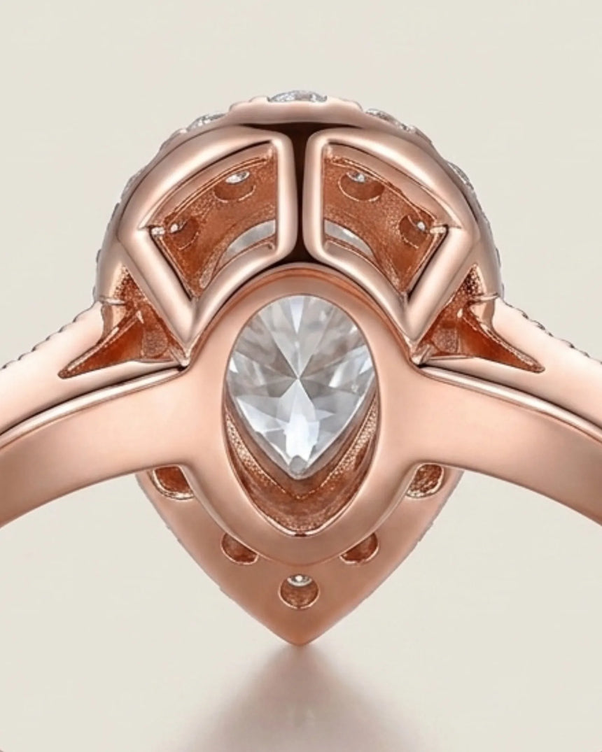 Luxury pear moissanite ring with halo, pavé band, and warm rose gold setting - SARATTI
