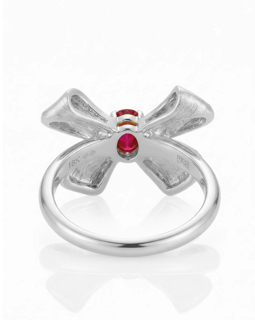 Macro detail pigeon blood ruby and pavé diamonds ribbon design 18K white gold | SARATTI