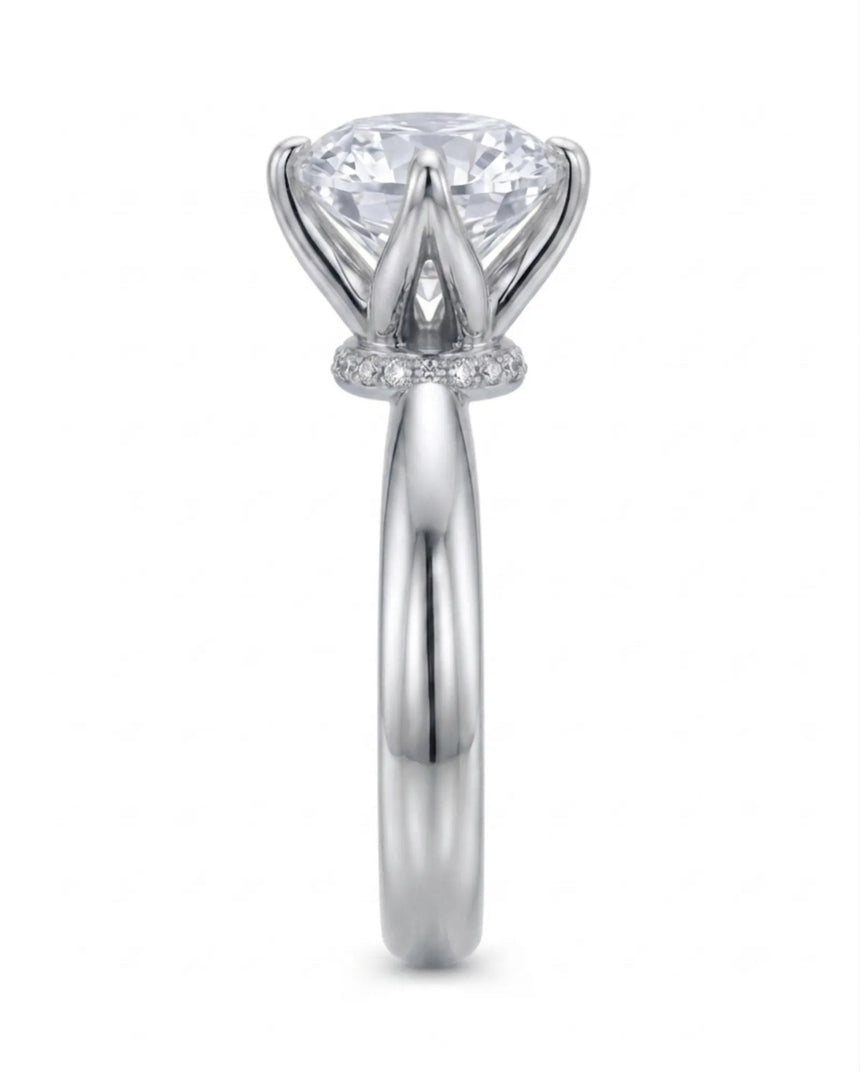 Minimal round moissanite ring with sculptural floral setting and polished platinum band | SARATTI