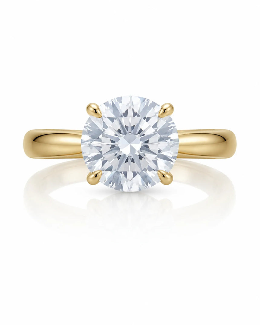 Minimal round moissanite ring with sculptural floral setting and polished yellow gold band | SARATTI