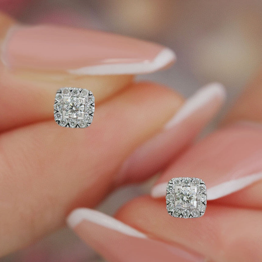 White Gold Natural Diamond Stud Earrings held up by Model | Saratti | Custom High and Fine Jewelry