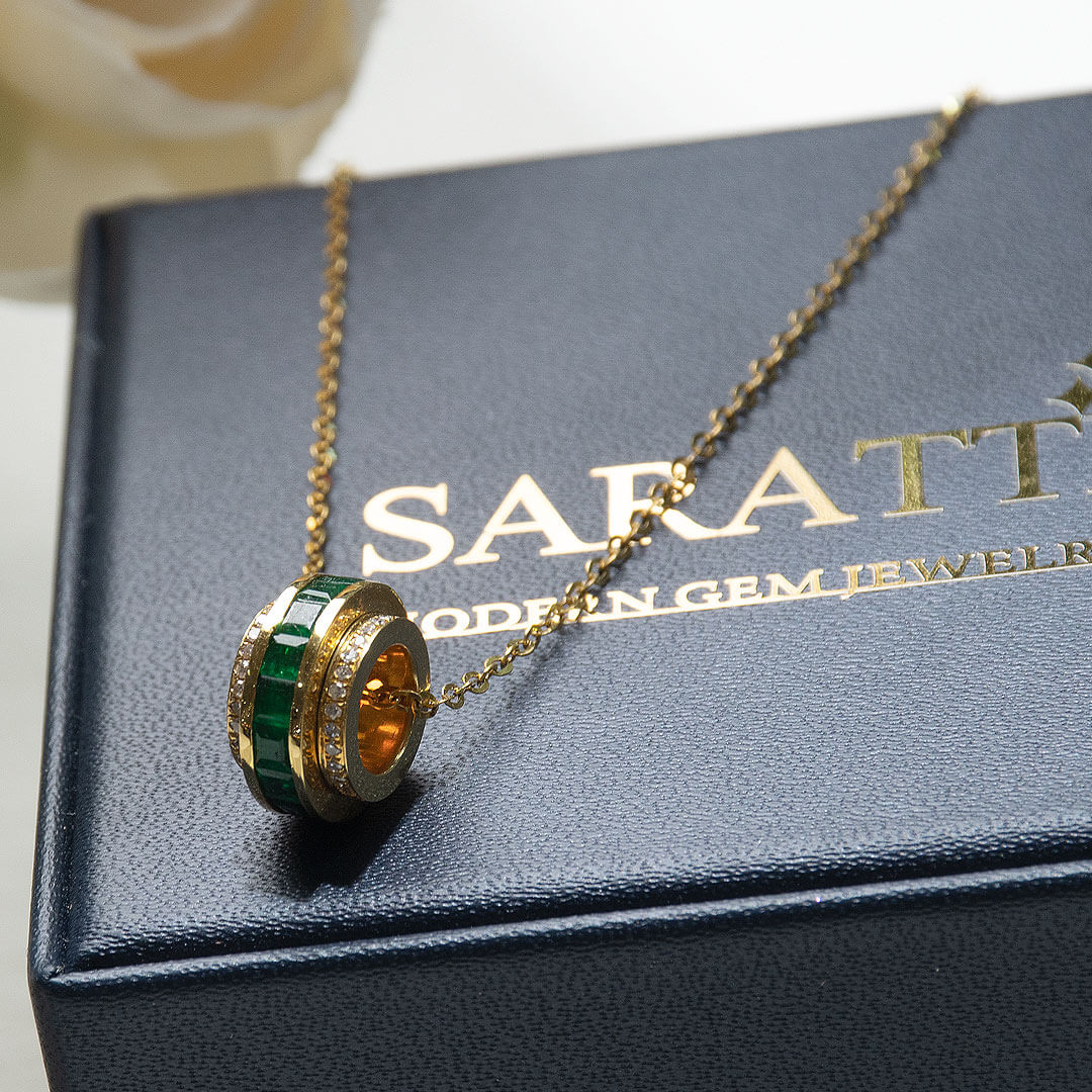 Yellow Gold Roulette Verte Emerald Pendant Necklace against the Saratti Jewelry Box | Saratti Fine Jewelry