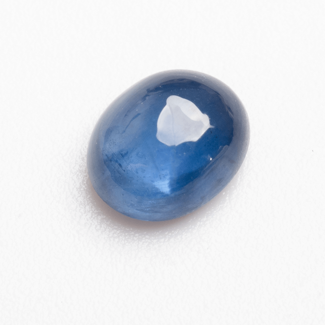 Natural 0.89 carat blue sapphire cabochon photographed on white background | SARATTI