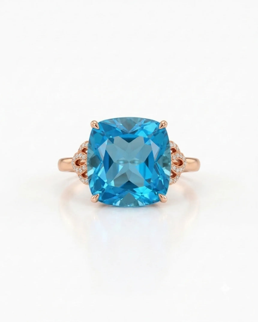 Natural cushion Swiss Blue topaz ring framed by sculpted diamond details in 18K rose gold | SARATTI