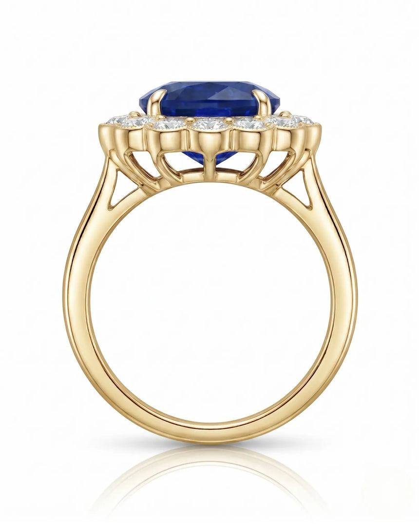 Natural oval sapphire ring framed by bright round diamonds in 18K yellow gold | SARATTI