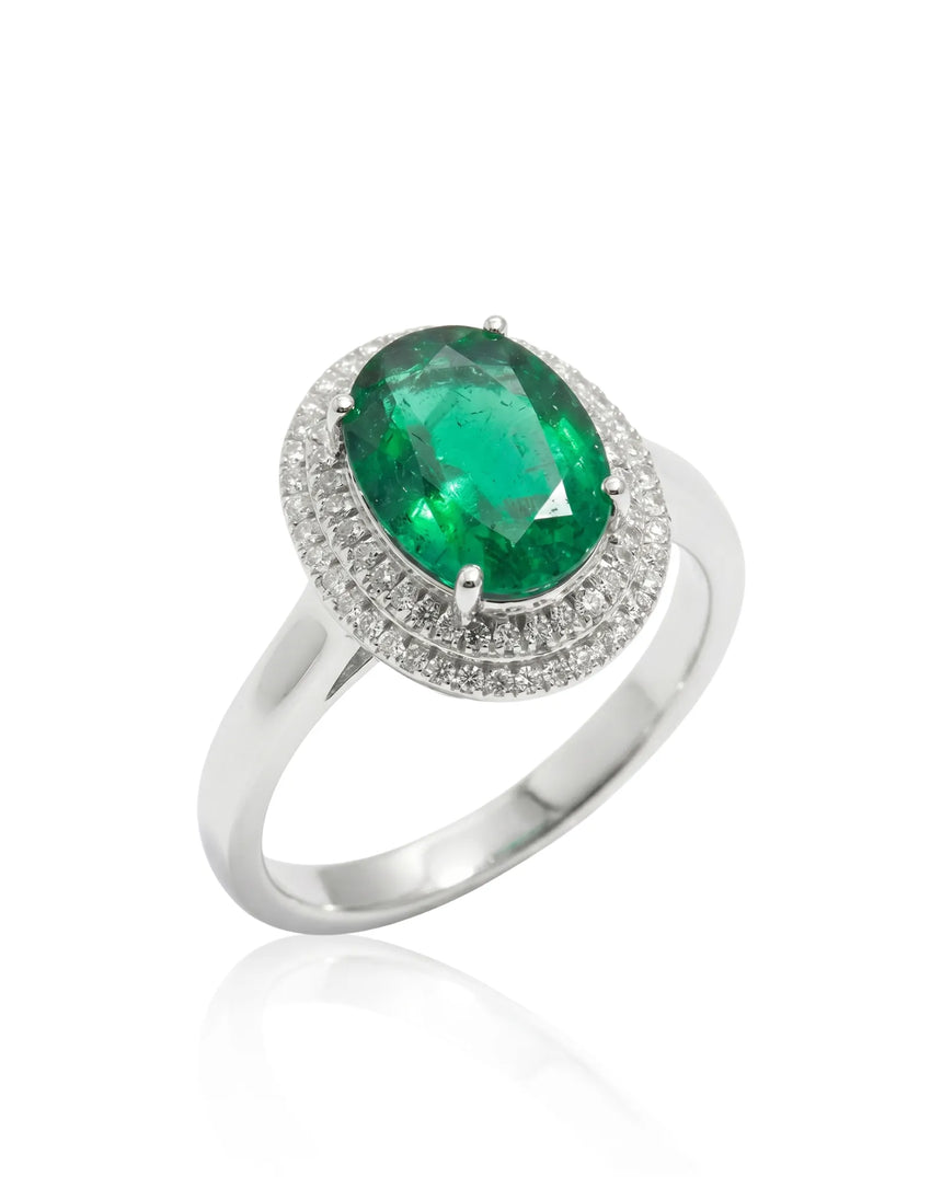 Oval Halo Eterna natural emerald and diamond ring in platinum | SARATTI