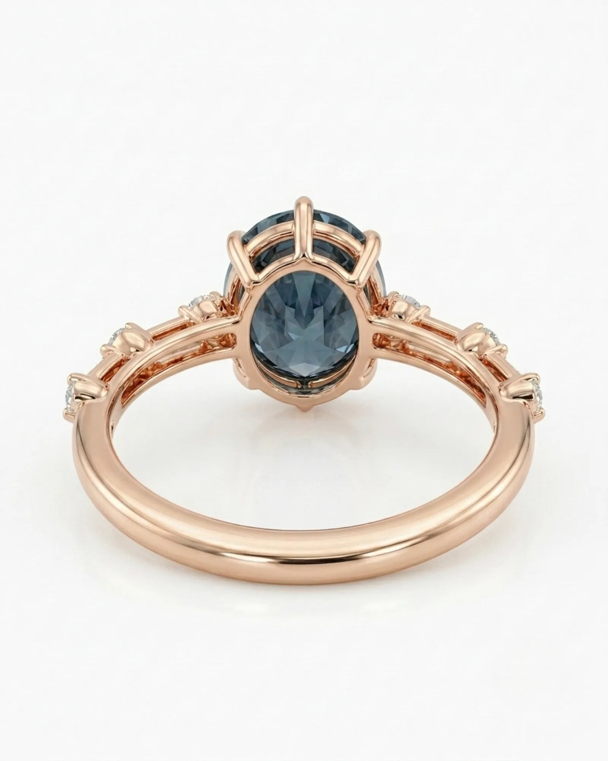 Oval blue moissanite center with colorless round side stones in 18K rose gold | SARATTI