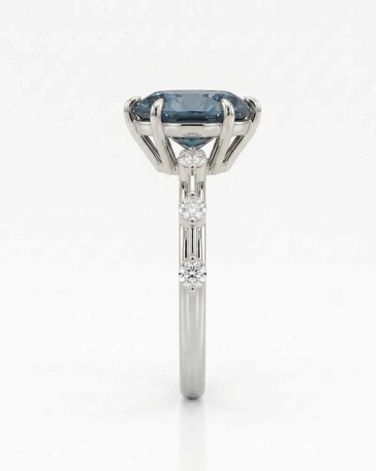 Oval blue moissanite center with colorless round side stones in polished platinum | SARATTI
