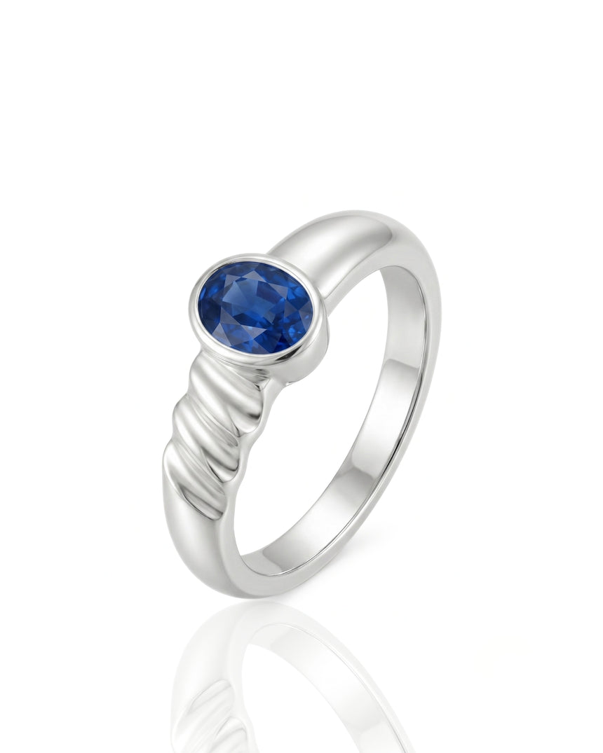 Oval blue sapphire solitaire ring with bezel setting and grooved Platinum band | SARATTI