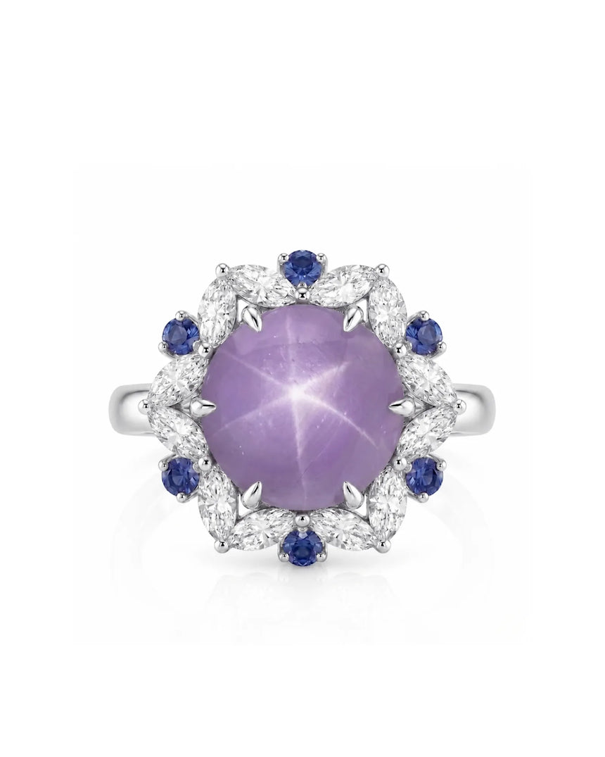 Oval cabochon natural star sapphire ring with blue sapphire accents in 18K white gold | SARATTI